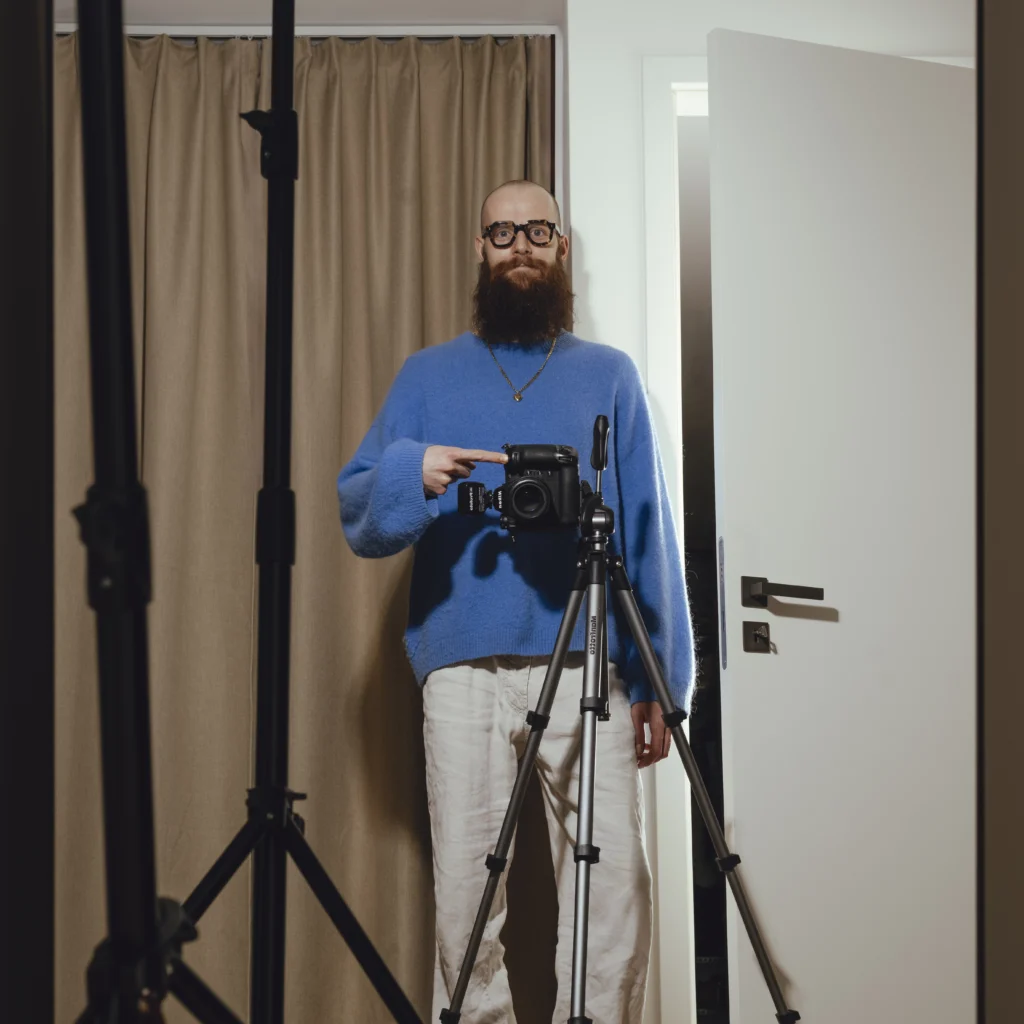 Photographer with Studio setup taking a self portrait in a mirror